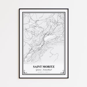 May include: A framed black and white map print of Saint Moritz, Switzerland. The map features detailed line art of the city's layout, with the city name and coordinates displayed in a serif font. The print is encased in a black frame.