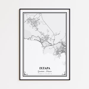 May include: A framed black and white map print of Ixtapa, Guerrero, Mexico. The map details the city's layout with roads and buildings. The city name and coordinates are printed below the map. The print is in a black frame.