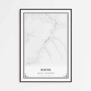 May include: A framed black and white map print of Davos, Switzerland. The print features the city's name, region, and coordinates in a minimalist design. The map is detailed with roads and terrain, set against a light gray background.