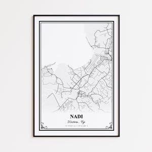 May include: A framed black and white map print of Nadi, Western, Fiji. The map features detailed road and geographical outlines. The text "NADI Western, Fiji" is centered at the bottom, with coordinates below. The print is encased in a black frame.