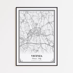 May include: A framed black and white map print of Vicenza, Italy. The map shows the city's road network and is labeled with the city's name and coordinates. The print is in a black frame and is suitable for home decor.