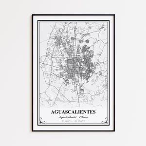 May include: A framed black and white map print of Aguascalientes, Mexico. The map details the city's streets and infrastructure. The city name and coordinates are printed at the bottom. The print is encased in a black frame.