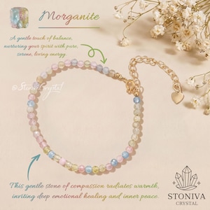 May include: A delicate bracelet featuring small, multi-coloured faceted beads in shades of pink, blue, yellow, and clear. The bracelet includes a gold-toned metal chain with a lobster clasp and a small heart-shaped charm at the end of the extender.