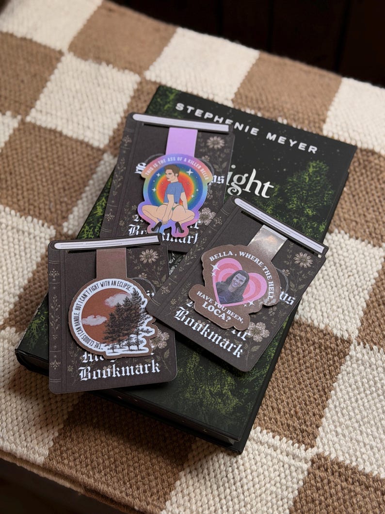 May include: Three magnetic bookmarks featuring Twilight-themed designs. One shows a character with the text 'THIS IS THE SKIN OF A KILLER BELLA', another a forest scene with 'THE CLOUDS I CAN HANDLE BUT I CAN'T FIGHT WITH AN ECLIPSE', and one with 'BELLA WHERE THE HELL HAVE YOU BEEN LOCA?'
