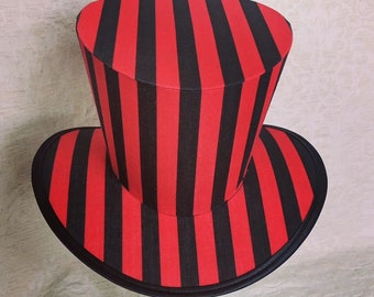 May include: A black and red striped top hat with a wide brim. The hat is made of fabric and has a classic top hat shape.