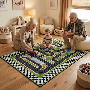 May include: A rectangular area rug featuring a printed race track design with black asphalt paths, green grass, palm trees, and a checkered border. The rug displays a detailed circuit layout with curves, straightaways, and a central building structure.
