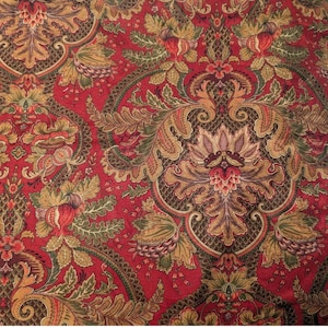 May include: A fabric featuring a dense damask pattern in shades of deep red, olive green, and gold. The design consists of intricate floral motifs, scrolling acanthus leaves, and pomegranate shapes arranged in a repeating, symmetrical layout.