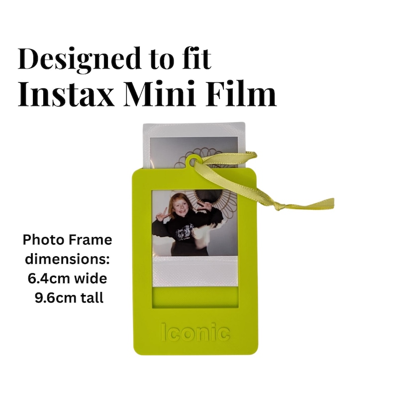 May include: A lime green photo frame designed for Instax Mini Film, with a photo inside. The frame is 6.4cm wide and 9.6cm tall, with a yellow ribbon attached. The word "Iconic" is printed on the bottom.