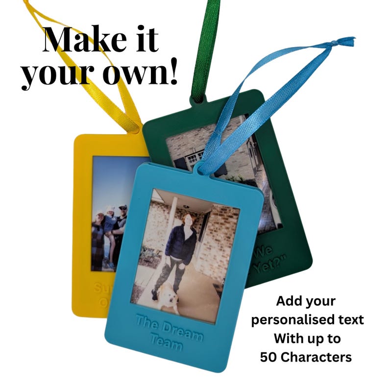 May include: Three rectangular photo frames in yellow, teal, and green, each with a ribbon for hanging. The teal frame has the text "The Dream Team". The text "Make it your own!" is at the top.