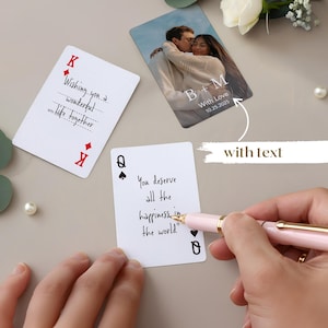 May include: Playing cards with handwritten text and a photo card. One card reads "Wishing you a wonderful life together." Another says "You deserve all the happiness in the world." The photo card shows a couple with the text "B+M With Love 10.25.2025."