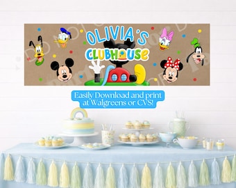 May include: A rectangular party banner featuring the text Olivia's Clubhouse in blue and green letters. The design includes cartoon character faces of Mickey, Minnie, Donald, Daisy, Goofy, and Pluto against a brown background with colorful dots.