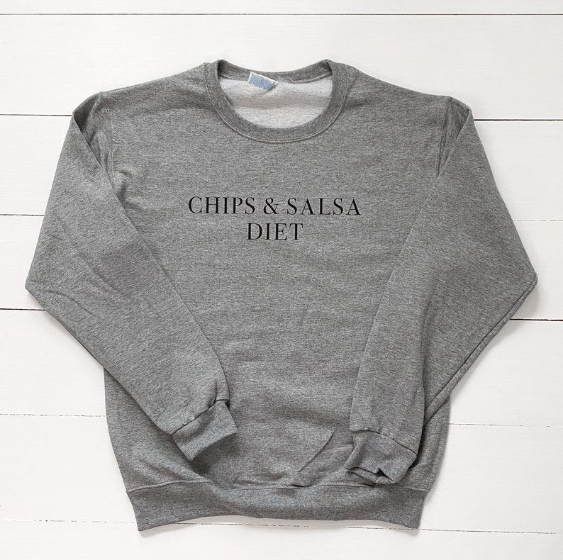 May include: Grey sweatshirt with the text "Chips & Salsa Diet" printed on the front.