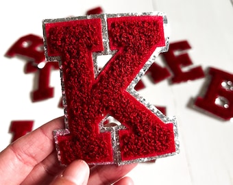 May include: Red felt letter K with silver glitter trim. The letter is thick and fuzzy, and it is perfect for adding a touch of personality to any project.