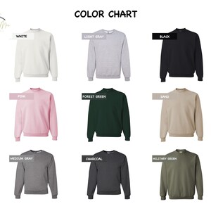 May include: Colour chart showing 10 different sweatshirt colours: white, light grey, black, pink, forest green, sand, medium grey, charcoal, military green.