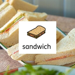 May include: A platter of triangular white bread sandwiches with visible ham and green fillings. A white square overlay in the centre displays a cartoon illustration of a sandwich above the lowercase black text that reads sandwich.