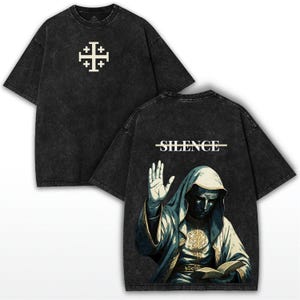 May include: Black t-shirt with a white Jerusalem cross on the front. The back features a graphic of a robed figure with the word "SILENCE" above it. The shirt has a vintage, washed look.