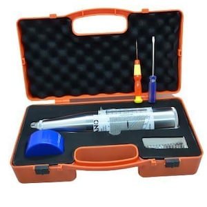 May include: An orange toolbox with a black foam interior, containing a silver and white instrument, two screwdrivers, a blue cap, and a small compartment with screws. The toolbox has a handle and a latch.
