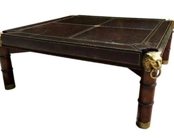 Mahogany large coffee table. Leather wrapped top, brass lion heads on corners and bamboo legs. This table is a grandmillenial dream.