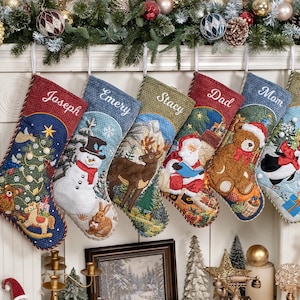 May include: Six personalized Christmas stockings hanging in a row, each featuring unique embroidered names: Joseph, Emery, Stacy, Dad, Mom, and Kim. The stockings display festive scenes including a snowman, reindeer, Santa, a teddy bear, and a penguin.
