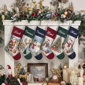 May include: Six Christmas stockings hanging in a row, each featuring a unique holiday scene including Santa, a reindeer, a snowman, a penguin, a Christmas tree, and a polar bear. Each stocking has a personalised name embroidered on the cuff.