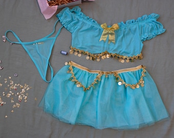 May include: A bright turquoise two-piece set consisting of an off-the-shoulder crop top with ruffled sleeves, a gold bow, and gold coin trim, paired with a matching tulle skirt featuring gold coin accents and a turquoise thong with thin straps.