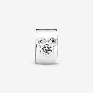 May include: A silver charm with a Mickey Mouse design. The charm features three clear, round, sparkling stones, with the largest stone in the center. The charm is rectangular with rounded edges.