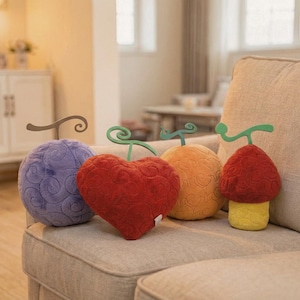 May include: A set of four plush toys featuring stylized fruit shapes with swirling patterns. The collection includes a round purple plush, a heart-shaped red plush, a round orange plush, and a mushroom-shaped red and yellow plush.