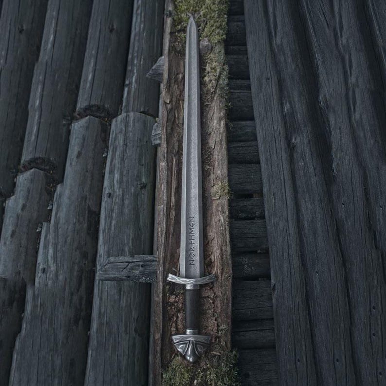 Handmade Viking sword with a Carbon steel blade and full tang design, featuring a detailed wave pattern. Comes with a custom hand-carved leather sheath, perfect for collectors or as a unique gift for men.
