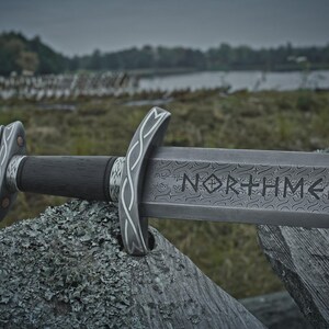 Handmade Viking sword with a Carbon steel blade and full tang design, featuring a detailed wave pattern. Comes with a custom hand-carved leather sheath, perfect for collectors or as a unique gift for men.