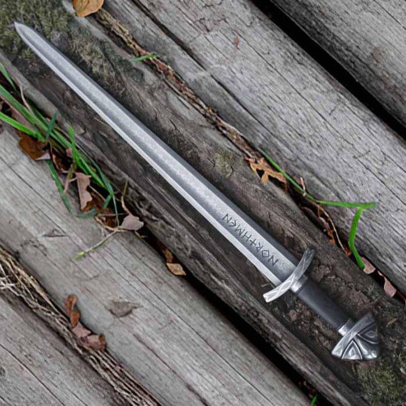Handmade Viking sword with a Carbon steel blade and full tang design, featuring a detailed wave pattern. Comes with a custom hand-carved leather sheath, perfect for collectors or as a unique gift for men.