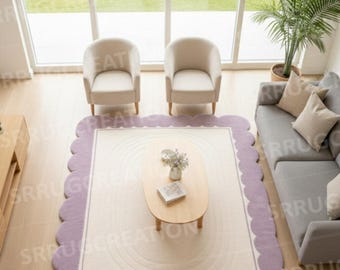 May include: A living room scene featuring a large, rectangular rug with a scalloped lavender border. The rug is centered in the room, with a light-colored interior and a subtle circular design. Two cream-colored armchairs and a wooden coffee table are visible.