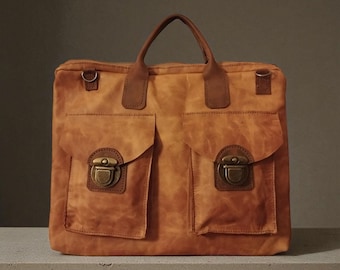 May include: A tan leather satchel with two front pockets and brass-coloured clasps. The bag has a top handle and two small rings on the sides. The leather has a distressed appearance.