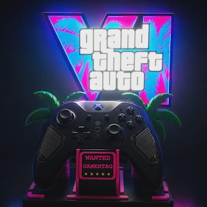 May include: A black video game controller resting on a stand featuring a pink and blue illuminated sign with the text Grand Theft Auto V. The stand includes a small rectangular sign with the text WANTED GAMERTAG and five yellow stars.