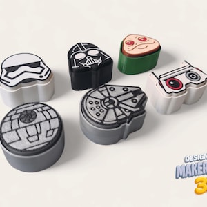 May include: A selection of 3D-printed bottle stoppers featuring Star Wars characters. Designs include Darth Vader, a Stormtrooper, the Death Star, and the Millennium Falcon. The stoppers are in black, white, grey, and green, with the Makerpeace 3D logo.