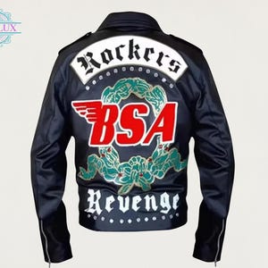 May include: Black jacket with "Rockers" and "BSA" patches. The back of the jacket features a white patch with black lettering, a red and white logo, and green and white decorative elements. The jacket has a zipper on the sleeves.