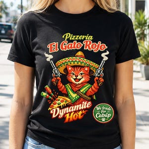 May include: A black t-shirt featuring a graphic of an orange tabby cat wearing a sombrero and a green poncho. The cat holds two smoking revolvers. Text reads Pizzeria El Gato Rojo, Dynamite Hot, and a green circle stating We trade for Catnip.