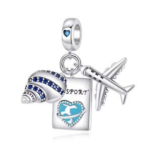 May include: A silver charm with travel-themed pendants. The charm includes a seashell with blue accents, a passport with the word "SPORT", and a small airplane. A blue heart is on the passport.