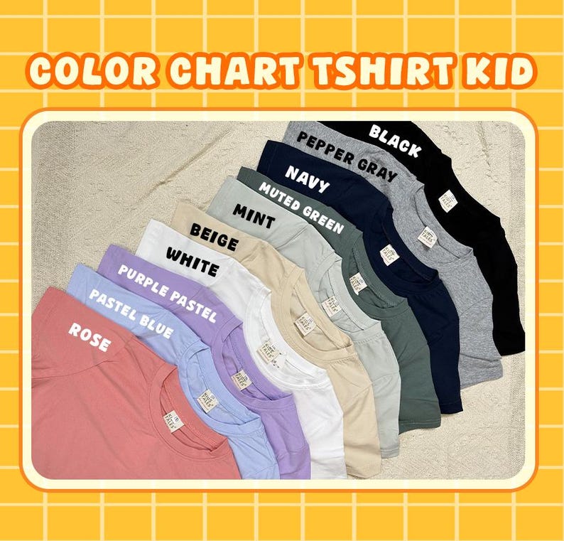 May include: A colour chart for kids' t-shirts displaying nine folded shirts in rose, pastel blue, purple pastel, white, beige, mint, muted green, navy, pepper gray, and black. Each shirt features a small white brand label at the inner neckline.