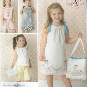 May include: A sewing pattern for children's clothing, Simplicity pattern number 2391, featuring three different styles of dresses with embroidered details. The pattern includes instructions for making a matching bag.