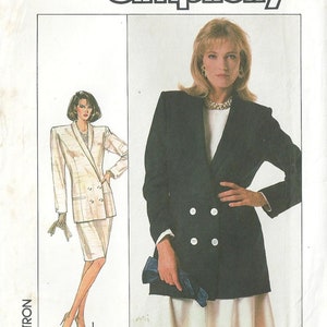 May include: Simplicity sewing pattern number 8385, size 12, for a double-breasted blazer and skirt. The pattern shows two models wearing the blazer and skirt in different colors. The blazer has a long, fitted silhouette and the skirt is a-line. The pattern is printed on white paper with black text.