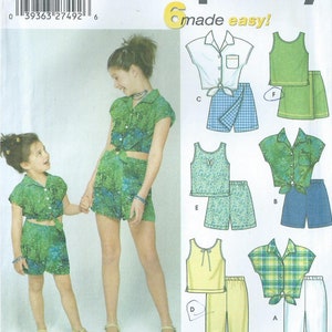 May include: Simplicity sewing pattern number 5163, made easy, for sizes 3, 4, 5, and 6. The pattern includes six different outfits for girls, including a green and white plaid shirt with white pants, a yellow tank top with yellow pants, a green and white floral tank top with green and white floral shorts, a green and white floral shirt with green and white floral shorts, a white shirt with blue and white gingham shorts, and a green tank top with a green skirt.