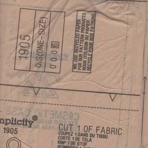 May include: A close-up of a tan sewing pattern with the number 1905 and the text "O.S (ONE-SIZE)". The pattern includes instructions in multiple languages, including English and French. The text "WE USE RECYCLED PAPER" is also visible.
