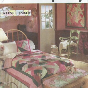 May include: A Simplicity pattern for a quilt, featuring a pink and green patchwork design. The pattern is called "The Lena-Claire by Leslie Levison Collection".