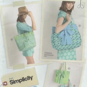 May include: A Simplicity sewing pattern with a Lisette design. The pattern shows a tote bag and a handbag in a light green and blue diamond pattern. The text "FOREIGN EXCHANGE BAG" is visible.