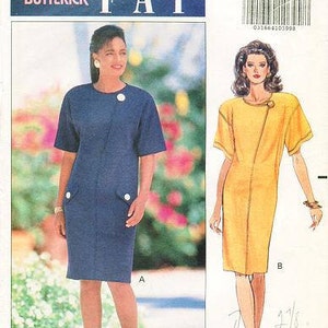 May include: A sewing pattern for a dress, featuring two models wearing different versions of the dress. The model on the left is wearing a navy blue dress with a button detail, and the model on the right is wearing a yellow dress with a similar button detail. The pattern number is 5408 and the size is 12-14-16.