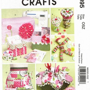 May include: Sewing craft pattern with instructions for making a pincushion, a sewing machine cover, a button box, a button holder, and an apron. The pattern is for size OSZ and is from McCall's Crafts.