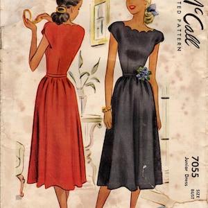 May include: Vintage McCall's sewing pattern for a junior dress, size 15, bust 33, 25c. The pattern shows two women wearing dresses, one in red and one in black. The pattern is printed on a light brown paper with the McCall's logo and the words "Printed Pattern" in the top right corner.
