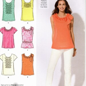 May include: A sewing pattern for a sleeveless top with a ruffled neckline. The pattern includes five different variations of the top, with different necklines and sleeve styles. The pattern is for sizes 12-20. The pattern is from Simplicity.