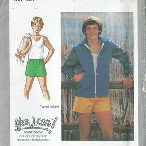 May include: Simplicity sewing pattern number 9127 for a teen boy. The pattern includes instructions for beginners and features a blue jacket with a white zipper and a pair of yellow shorts with white stripes.