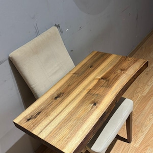 Solid wood sink countertop highlighting authentic live edge contour.